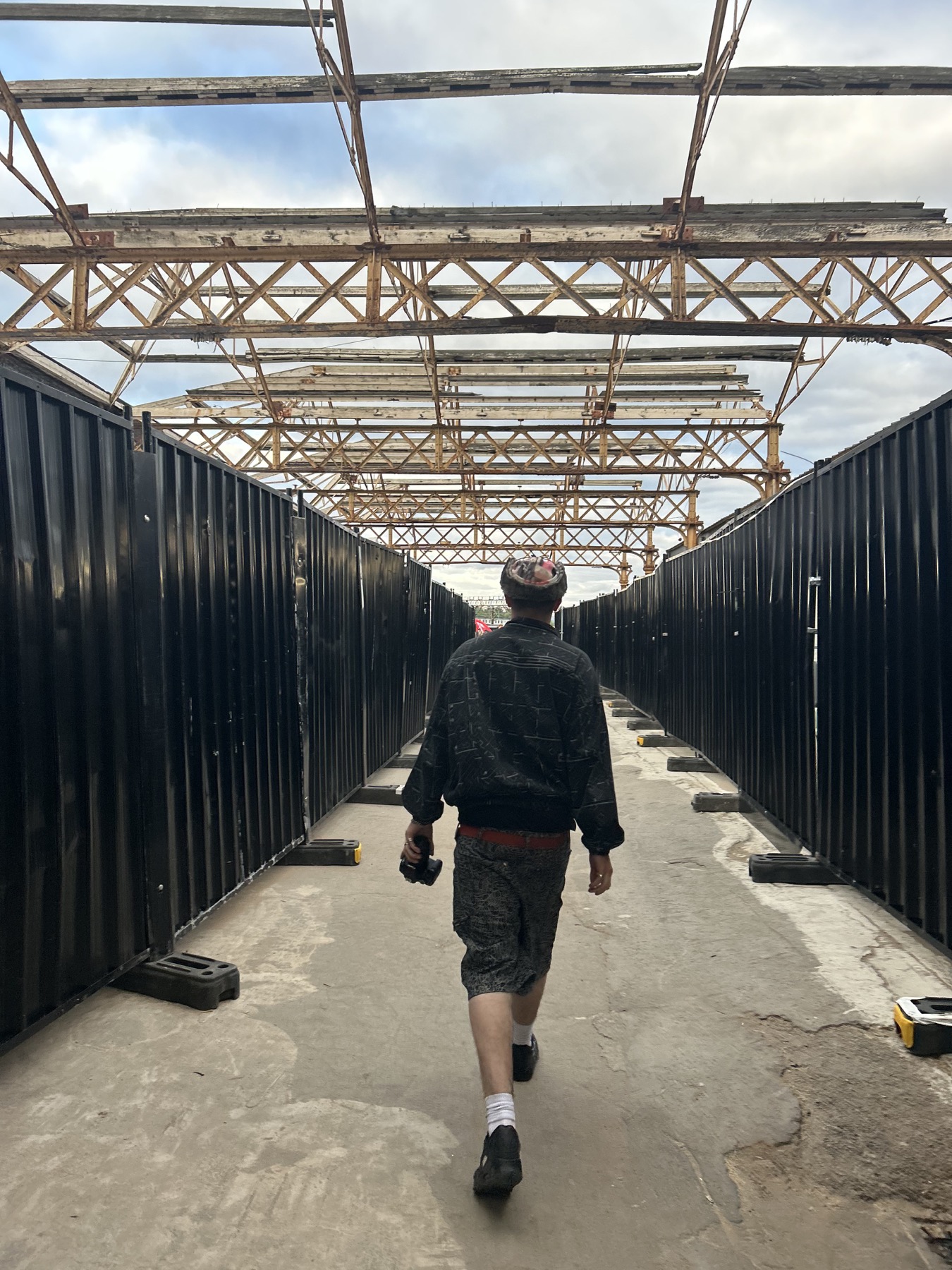Benji walking through an industrial location with his camera