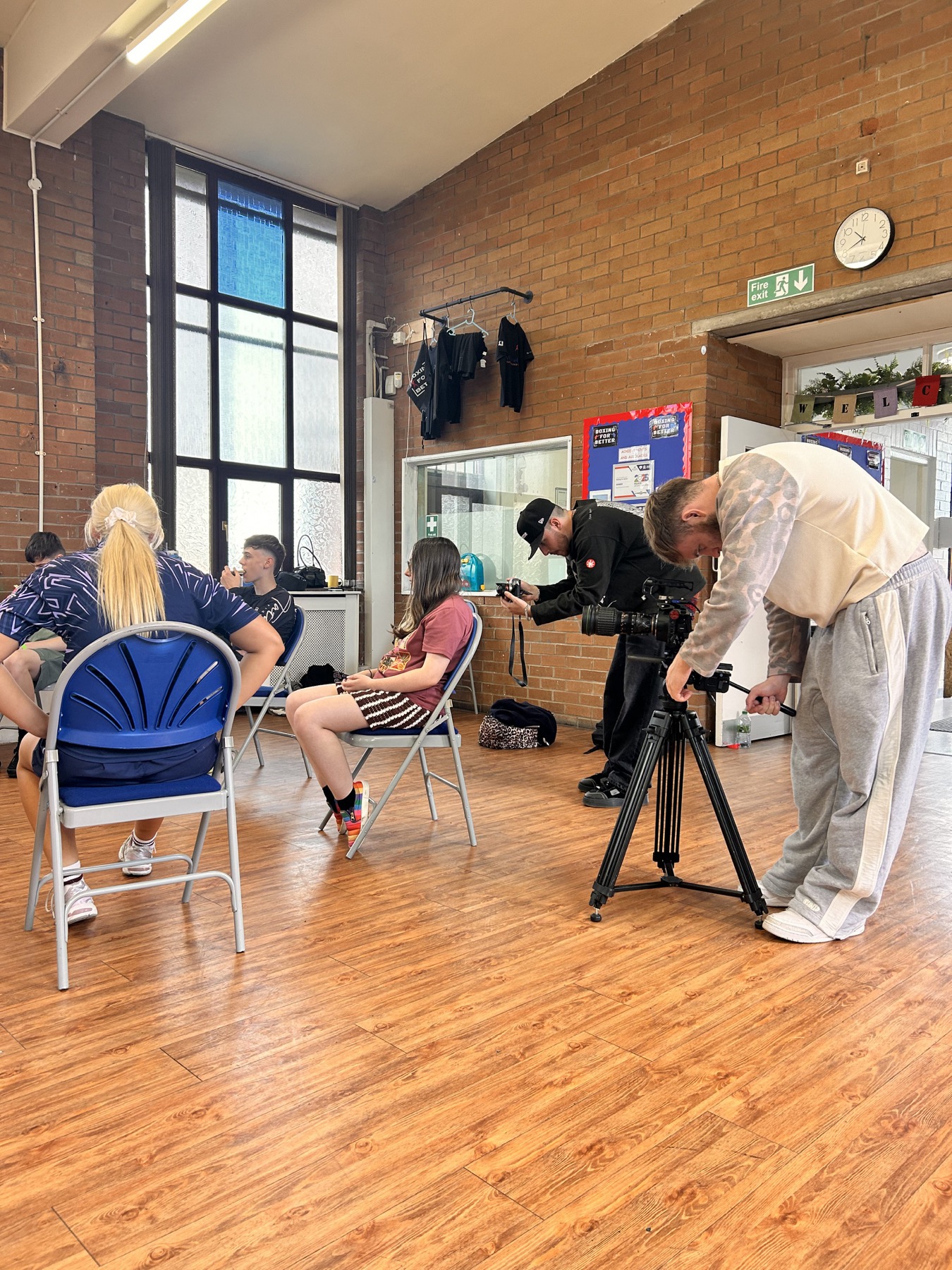 Camera crew filming inside a Manchester community space